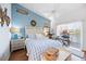 Cozy main bedroom with vaulted ceiling, blue walls, a ceiling fan, and a scenic view at 6314 Bay Cedar Ln # 201, Bradenton, FL 34203