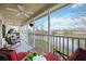 Relaxing screened porch overlooking a serene lake view, complete with comfortable seating and a ceiling fan at 6314 Bay Cedar Ln # 201, Bradenton, FL 34203