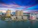 Aerial view of condos with city skyline views, showcasing the property's prime coastal location at 101 Sunset Dr # 102, Sarasota, FL 34236