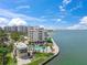 Aerial view of waterfront condos with a pool, showcasing the property's prime coastal location at 101 Sunset Dr # 102, Sarasota, FL 34236