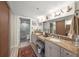 Spacious bathroom boasts a double sink vanity, granite counters, and a glass enclosed shower at 101 Sunset Dr # 102, Sarasota, FL 34236
