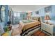 Cozy bedroom with a king bed, ample natural light, and a treadmill overlooking the ocean at 101 Sunset Dr # 102, Sarasota, FL 34236