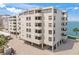 Modern condo building with balconies and waterfront views, showcasing contemporary architecture and design at 101 Sunset Dr # 102, Sarasota, FL 34236