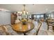 Charming dining room with a round table, chandelier, and scenic water view at 101 Sunset Dr # 102, Sarasota, FL 34236
