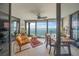 Comfortable seating area with floor-to-ceiling windows offering expansive ocean views and dining area at 101 Sunset Dr # 102, Sarasota, FL 34236