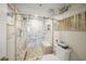 Modern glass shower featuring a marble tile surround, built-in seat, and convenient grab bars at 101 Sunset Dr # 102, Sarasota, FL 34236