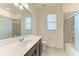 Well-lit bathroom with a single sink, integrated shower, and modern fixtures and finishes at 10111 Malachite Dr, Bradenton, FL 34211