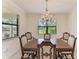 Elegant dining room features a wooden table with six chairs and decorative chandelier at 10111 Malachite Dr, Bradenton, FL 34211
