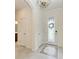 Bright foyer with decorative front door, tiled floors, and elegant chandelier leading into the home at 10111 Malachite Dr, Bradenton, FL 34211