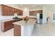 Spacious kitchen featuring an island with granite countertops, stainless appliances, and stylish wooden cabinetry at 10111 Malachite Dr, Bradenton, FL 34211