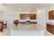 Open kitchen with a large island, granite countertops, stainless steel appliances and dark wood cabinets at 10111 Malachite Dr, Bradenton, FL 34211