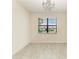 Versatile office space with a modern chandelier and serene views of the outdoors at 10111 Malachite Dr, Bradenton, FL 34211