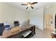 Home office with wood-look floors, ceiling fan, and large desk with ample workspace at 10111 Malachite Dr, Bradenton, FL 34211