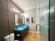 Modern bathroom with double sinks, unique turquoise countertops and sleek glass shower at 1020 Sun N Sea Dr # 104B, Sarasota, FL 34242