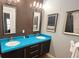 Stylish bathroom with modern fixtures, turquoise countertops and decorative mirrors for a sleek aesthetic at 1020 Sun N Sea Dr # 104B, Sarasota, FL 34242