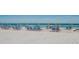 Inviting beach scene with chairs and umbrellas set up along the pristine shoreline at 1020 Sun N Sea Dr # 104B, Sarasota, FL 34242