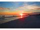 Sunset view of people enjoying a leisurely walk on the beach at 1020 Sun N Sea Dr # 104B, Sarasota, FL 34242