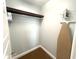 Functional closet space featuring an iron, ironing board and ample storage for organizational convenience at 1020 Sun N Sea Dr # 104B, Sarasota, FL 34242