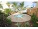 Outdoor hot tub surrounded by tropical plants and trees, perfect for relaxation at 1020 Sun N Sea Dr # 104B, Sarasota, FL 34242