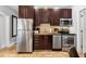 Modern kitchen featuring stainless steel appliances, dark cabinets, and stylish design elements at 1020 Sun N Sea Dr # 104B, Sarasota, FL 34242