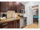 Modern kitchen with stainless steel appliances, dark wood cabinets, and updated fixtures at 1020 Sun N Sea Dr # 104B, Sarasota, FL 34242