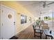 Inviting exterior patio with wooden flooring, ceiling fans, and comfortable seating area at 1020 Sun N Sea Dr # 104B, Sarasota, FL 34242