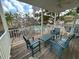 Outdoor porch featuring wood flooring, chairs, and a table, perfect for enjoying the beautiful view at 1020 Sun N Sea Dr # 104B, Sarasota, FL 34242