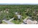 Stunning aerial view of the home nestled among lush greenery, showcasing its prime location and serene neighborhood at 1046 Greystone Ln, Sarasota, FL 34232