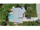 Aerial view showcases the pool and lushly landscaped grounds of this property, nestled within a verdant neighborhood at 1046 Greystone Ln, Sarasota, FL 34232