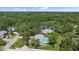 Aerial shot of a home featuring a sparkling pool, spacious yard, and beautifully landscaped surroundings in a serene neighborhood at 1046 Greystone Ln, Sarasota, FL 34232