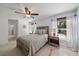 Bright bedroom features a ceiling fan and plenty of natural light at 1046 Greystone Ln, Sarasota, FL 34232