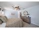 This bedroom has a ceiling fan, a wooden dresser with decorative mirror and light neutral colors at 1046 Greystone Ln, Sarasota, FL 34232