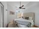 Light bedroom features a bed with white and grey blankets, ceiling fan and a small side table at 1046 Greystone Ln, Sarasota, FL 34232