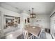 An open dining room with blue rug, light fixture and view of the kitchen and living room at 1046 Greystone Ln, Sarasota, FL 34232