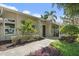 Inviting entrance of this lovely home showing manicured landscaping and walkway at 1046 Greystone Ln, Sarasota, FL 34232