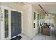 Welcoming front porch with comfortable seating and stylish front door with sidelight at 1046 Greystone Ln, Sarasota, FL 34232