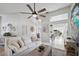 Bright, spacious living room features a modern ceiling fan and open layout to dining area at 1046 Greystone Ln, Sarasota, FL 34232