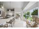 Living space features dining area, island with bar stool seating and plenty of natural light at 1046 Greystone Ln, Sarasota, FL 34232