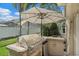 Outdoor grill area with built-in barbecue, surrounded by lush landscaping, perfect for al fresco dining and entertaining at 1046 Greystone Ln, Sarasota, FL 34232