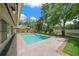 Gorgeous pool with a spacious tiled patio, lush landscaping, and serene privacy, perfect for relaxing and enjoying the outdoors at 1046 Greystone Ln, Sarasota, FL 34232