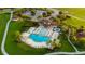 An aerial view of the community pool with clubhouse, hot tub, playground, and gazebo at 11702 Tetrafin Dr, Riverview, FL 33579