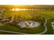 A beautiful aerial view of the community amenities including a pool, clubhouse, and recreational field at 11702 Tetrafin Dr, Riverview, FL 33579