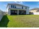 Large, grassy backyard with white fencing, and a screened-in porch on the home's exterior at 11702 Tetrafin Dr, Riverview, FL 33579