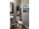 Tastefully decorated half bathroom with modern fixtures, decor and wood look floors at 11702 Tetrafin Dr, Riverview, FL 33579