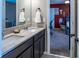 Bathroom vanity featuring granite countertops and dual sinks, with a glimpse into an adjacent bedroom at 11702 Tetrafin Dr, Riverview, FL 33579