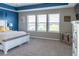 Bright bedroom with carpet flooring, tray ceiling, and three windows offering great natural light at 11702 Tetrafin Dr, Riverview, FL 33579