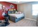 A bedroom featuring a plush bed frame with guitar decorations on the walls at 11702 Tetrafin Dr, Riverview, FL 33579