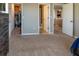 Spacious carpeted bedroom showing two open doors to a walk-in closet and an ensuite bath at 11702 Tetrafin Dr, Riverview, FL 33579