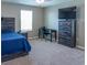 Bedroom featuring a wood bed frame, a desk for a home office and a dresser with a TV on top at 11702 Tetrafin Dr, Riverview, FL 33579