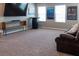 Spacious upstairs bonus room has a large TV for recreation at 11702 Tetrafin Dr, Riverview, FL 33579